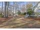 Landscaped backyard featuring a fire pit and natural surroundings at 1040 Millridge Se Ln, Marietta, GA 30067