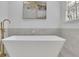Modern bathroom featuring a freestanding tub with gold fixtures, stylish tile, and a serene atmosphere at 1040 Millridge Se Ln, Marietta, GA 30067