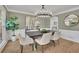 Elegant dining room featuring modern chandelier, hardwood floors, and natural light at 1040 Millridge Se Ln, Marietta, GA 30067