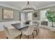 Elegant dining room featuring modern chandelier, hardwood floors, and natural light at 1040 Millridge Se Ln, Marietta, GA 30067