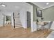 Bright foyer featuring hardwood floors, staircase, and an adjacent home office at 1040 Millridge Se Ln, Marietta, GA 30067