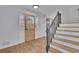 Bright foyer featuring hardwood floors, staircase, and wooden door with sidelights at 1040 Millridge Se Ln, Marietta, GA 30067