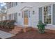 Inviting home entrance featuring a wooden door with glass and well-kept landscaping at 1040 Millridge Se Ln, Marietta, GA 30067