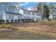 Traditional home with white exterior, showcasing lawn and manicured shrubbery at 1040 Millridge Se Ln, Marietta, GA 30067