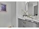 Stylish powder room featuring a gray vanity, marble countertop, gold fixtures, and modern decor at 1040 Millridge Se Ln, Marietta, GA 30067