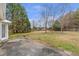 A view of the backyard showing the lawn, trees, and home's exterior at 2685 Archer Way, Dacula, GA 30019
