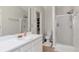 Bathroom featuring a vanity with ample counter space and storage and a glass-enclosed shower at 2685 Archer Way, Dacula, GA 30019