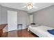 A bedroom with hardwood floors, a ceiling fan, and neutral tones at 2685 Archer Way, Dacula, GA 30019