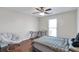 Comfortable bedroom with a neutral color scheme, hardwood floors, and a cozy seating area at 2685 Archer Way, Dacula, GA 30019
