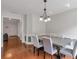 Elegant dining room with modern lighting, chair rail, and hardwood floors at 2685 Archer Way, Dacula, GA 30019
