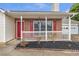 Inviting front porch with red door and shutters, a black mulch bed, and a well-maintained picket fence at 2685 Archer Way, Dacula, GA 30019