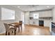 Bright kitchen area featuring white cabinets, stainless appliances, tile floors, and an adjacent breakfast nook at 2685 Archer Way, Dacula, GA 30019