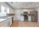 Updated kitchen with stainless steel appliances, white cabinets, and tiled floors at 2685 Archer Way, Dacula, GA 30019