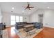 Open living space with vaulted ceilings, hardwood floors, and a cozy gray sectional sofa at 2685 Archer Way, Dacula, GA 30019