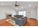 Bright living room featuring hardwood floors, a fireplace, and a comfortable gray sofa set at 2685 Archer Way, Dacula, GA 30019