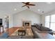 Cozy living room with a fireplace, hardwood floors, and modern gray furniture at 2685 Archer Way, Dacula, GA 30019