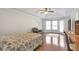 Spacious main bedroom showcasing hardwood floors, a ceiling fan, and an abundance of natural light at 2685 Archer Way, Dacula, GA 30019