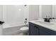 Cozy bathroom featuring a tub-shower combo and a sleek vanity with dark fixtures at 4480 Beechnut Cir, Cumming, GA 30028