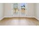 Bright, light-filled room featuring hardwood floors and double doors leading to a backyard view at 4480 Beechnut Cir, Cumming, GA 30028