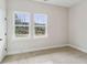 Bedroom with plush carpet, natural light, and a view of the landscaped backyard at 4480 Beechnut Cir, Cumming, GA 30028