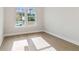 Bright bedroom with hardwood floors and large windows overlooking the yard at 4480 Beechnut Cir, Cumming, GA 30028