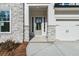 Charming front entrance with stone accents, white trim, and attached garage at 4480 Beechnut Cir, Cumming, GA 30028