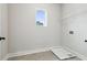 Bright laundry room with tile flooring and practical overhead shelving, ready for appliances at 4480 Beechnut Cir, Cumming, GA 30028