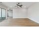 Spacious living room with wood floors, a ceiling fan, and sliding glass doors to the backyard at 4480 Beechnut Cir, Cumming, GA 30028