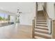 Bright living room with a wood staircase, wood floors, and a sliding glass door to the backyard at 4480 Beechnut Cir, Cumming, GA 30028