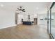 Open-concept living room with kitchen and stainless appliances plus wood floors and lots of natural light at 4480 Beechnut Cir, Cumming, GA 30028