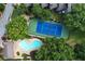 Aerial view of a community pool and tennis court surrounded by lush trees and landscaping at 29 Ivy Ne Trl, Atlanta, GA 30342