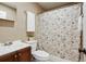 Bathroom featuring a shower with a floral curtain, and a sleek vanity with a stainless steel faucet at 29 Ivy Ne Trl, Atlanta, GA 30342