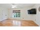 Comfortable bedroom with hardwood floors, a ceiling fan, and a large window at 29 Ivy Ne Trl, Atlanta, GA 30342