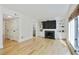 Bright living room with a fireplace, built-in shelving, and hardwood floors at 29 Ivy Ne Trl, Atlanta, GA 30342