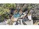 Aerial shot of backyard pool with a fountain and seating, surrounded by trees at 832 Forest Path Ln, Alpharetta, GA 30022
