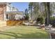 Stunning backyard featuring a fire pit, manicured lawn, and deck with covered seating area at 832 Forest Path Ln, Alpharetta, GA 30022