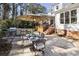 Backyard features a stone patio with outdoor dining and a built-in grill at 832 Forest Path Ln, Alpharetta, GA 30022