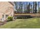 Lush backyard with green grass, neatly trimmed shrubs, and a wooden fence at 832 Forest Path Ln, Alpharetta, GA 30022