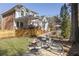 Inviting backyard with a stone patio featuring a fire pit, and an elevated deck at 832 Forest Path Ln, Alpharetta, GA 30022