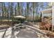 Beautiful backyard with outdoor dining, stone patio, and built in grill at 832 Forest Path Ln, Alpharetta, GA 30022