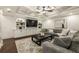 Finished basement featuring a coffered ceiling, comfortable seating, and built-in shelves at 832 Forest Path Ln, Alpharetta, GA 30022