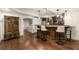 Basement wet bar featuring wood cabinets, barstool seating, and pendant lighting at 832 Forest Path Ln, Alpharetta, GA 30022