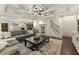 Finished basement featuring a coffered ceiling, living area, bar, and elegant staircase at 832 Forest Path Ln, Alpharetta, GA 30022
