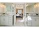 Dual sinks and large mirrors in the Primary bathroom lead to the light-filled Primary bedroom at 832 Forest Path Ln, Alpharetta, GA 30022