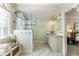 Bright bathroom featuring tiled floors, a tiled shower with a glass enclosure, and a vanity with storage at 832 Forest Path Ln, Alpharetta, GA 30022