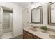 Bright bathroom with a granite countertop vanity, framed mirror, and tiled shower and tub at 832 Forest Path Ln, Alpharetta, GA 30022