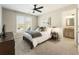Bedroom with a ceiling fan, large window, a TV, and an ensuite bathroom at 832 Forest Path Ln, Alpharetta, GA 30022
