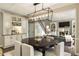 Open-concept dining area with modern light fixture and seamlessly connected to the living room at 832 Forest Path Ln, Alpharetta, GA 30022