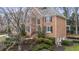 Beautiful brick house with manicured landscaping, black shutters, and mature trees at 832 Forest Path Ln, Alpharetta, GA 30022