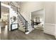 Elegant foyer with hardwood floors, staircase, and views into the living room and kitchen at 832 Forest Path Ln, Alpharetta, GA 30022